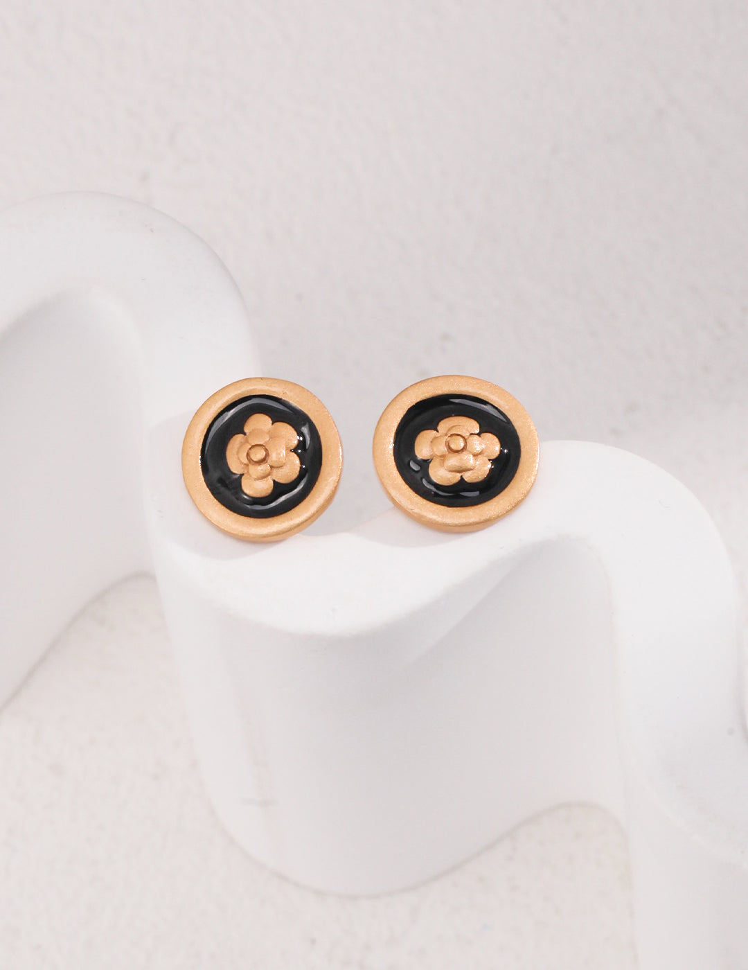 Noir Blossom Studs featuring 18ct gold vermeil with a vintage gold finish and black enamel floral design, offering elegance and sophistication.