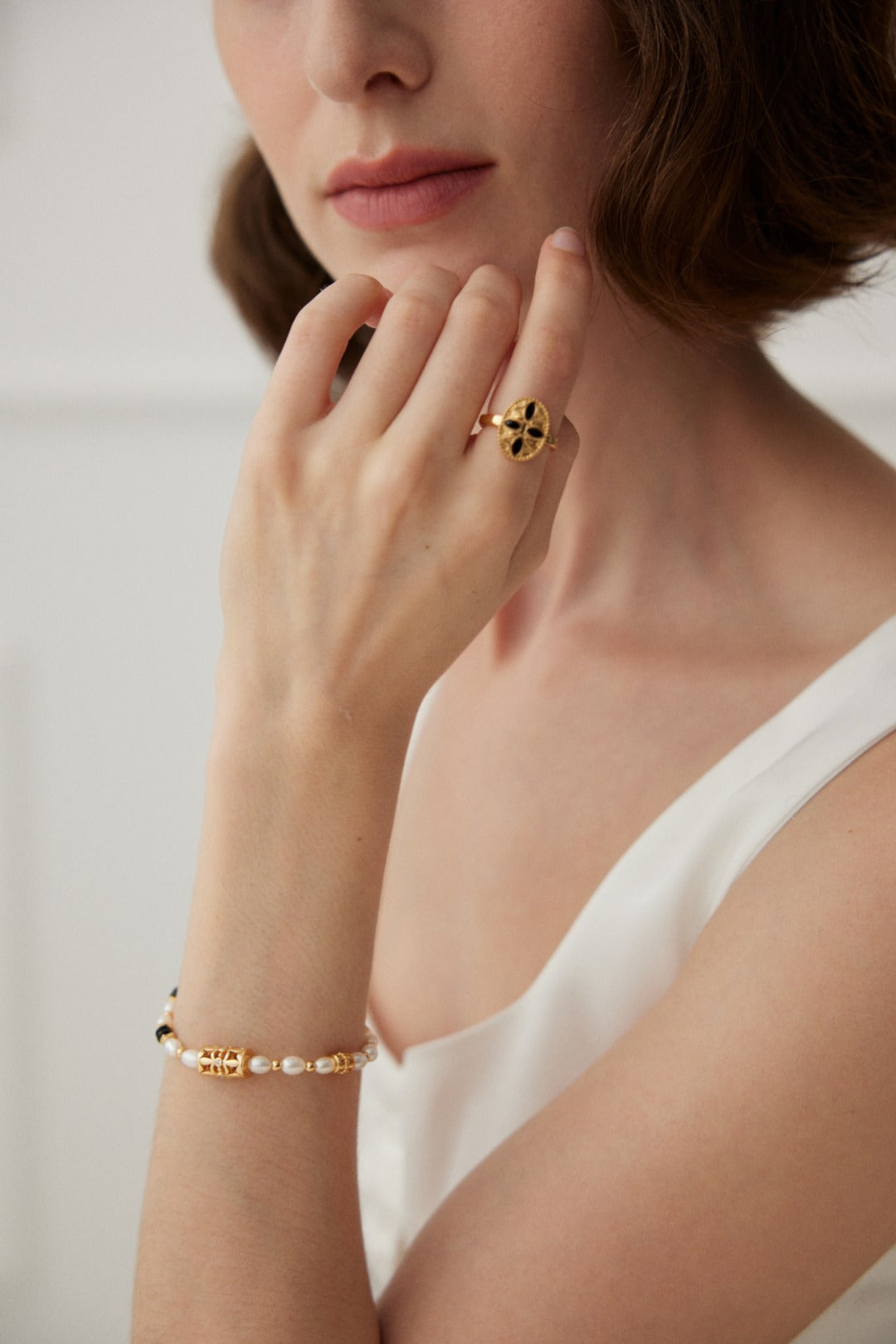 Golden Lotus Ring featuring 18ct gold vermeil and black enamel detailing, capturing vintage elegance with a timeless lotus design.