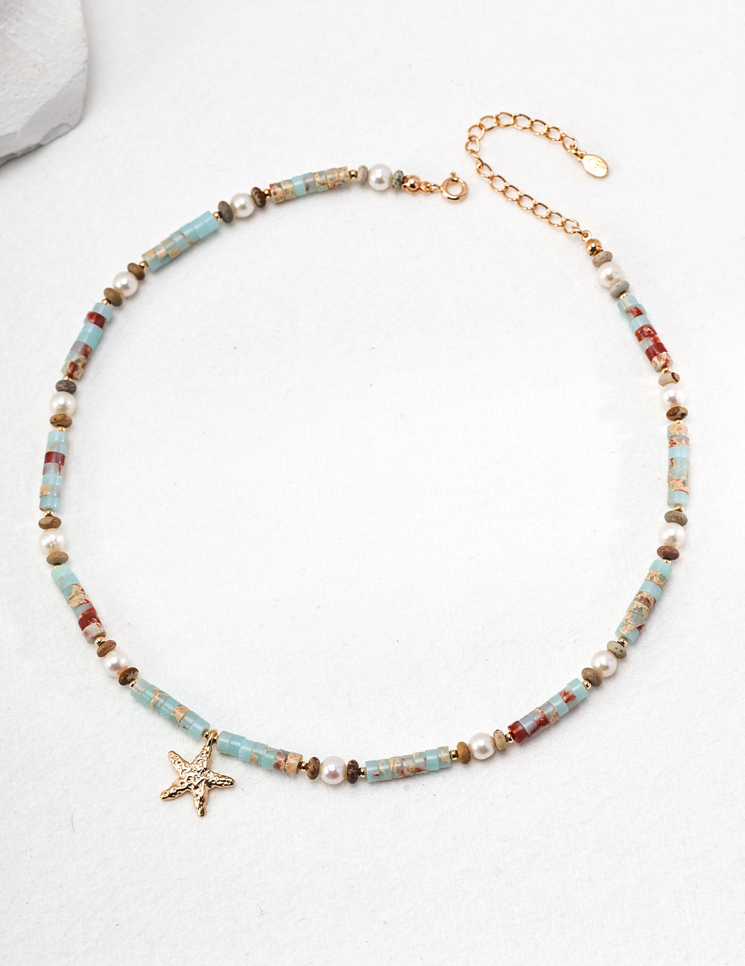 Hand-beaded Ocean Star Necklace with 18ct gold vermeil, featuring Shoushan stones, freshwater pearls, and a starfish charm, offering both beauty and emotional balance.